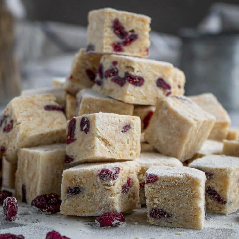 Handmade snowflake crisps with cranberries, chewy marshmallow base, no-bake dessert cubes